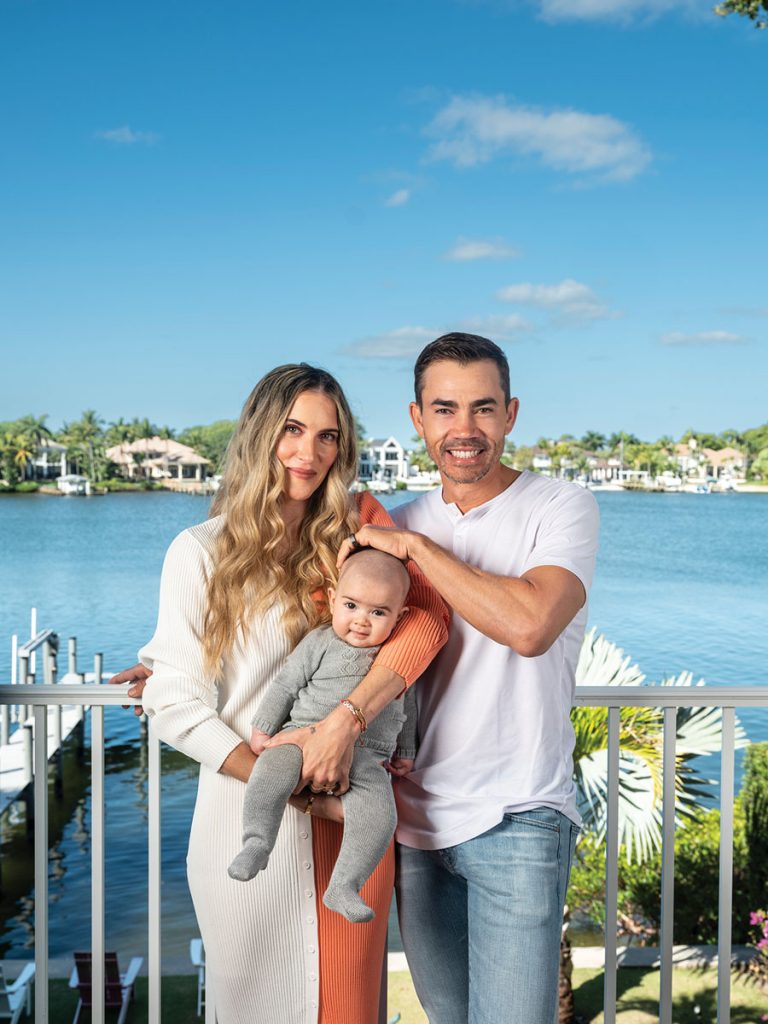 The family on the balcony of their Jupiter home on the Loxahatchee River. Photography by Benjamin Rusnak