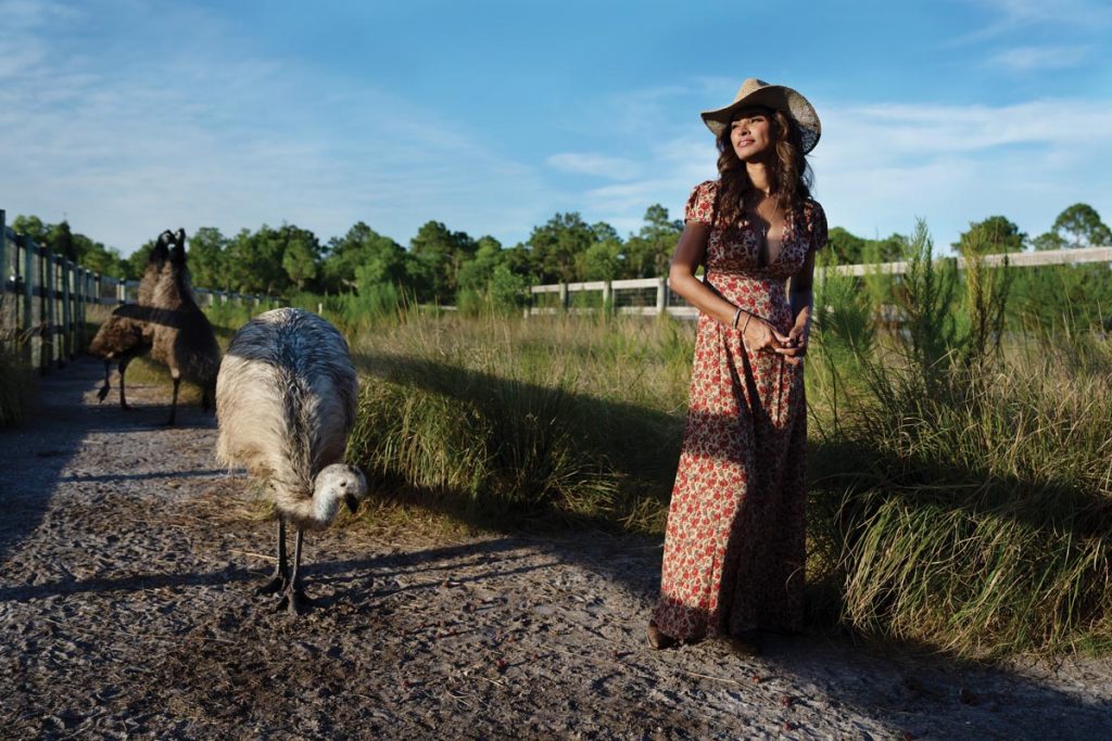 Karin Taylor takes a stroll with Juliette, one of five emus at Mandalay Farms. Photo by Steven Martine