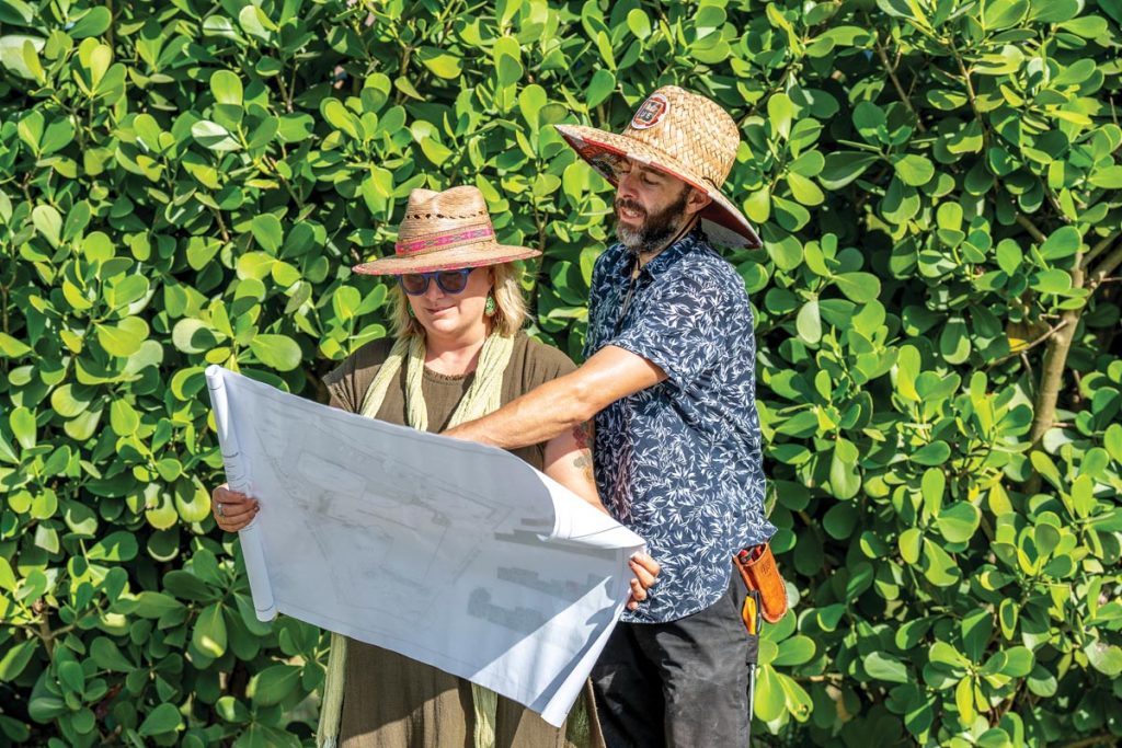 Leslie Bosson and her husband, lead horticulturist Enrique Gutierrez, review plans for a new landscape design. Photo by Marcos Schonholz