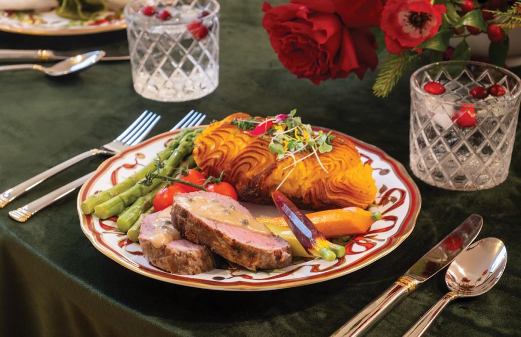 The tablescape—designed by Sarah Solomon and Angela Reynolds— featured Tiffany & Co. holiday-themed china atop a green velvet tablecloth. Photo by Jerry Rabinowitz